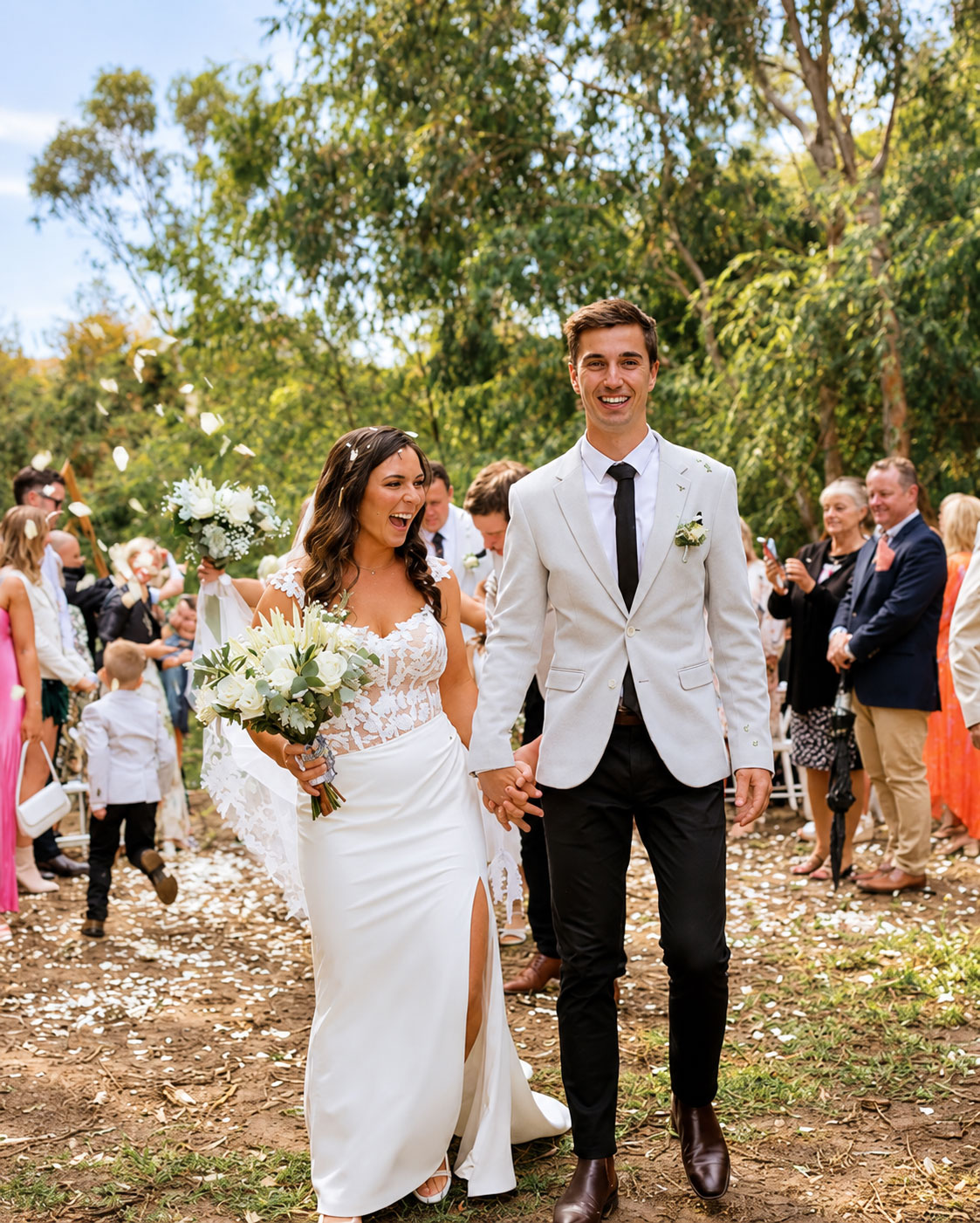Newlyweds laughing as they walk back down the aisle after their ceremony in Albury Wodonga